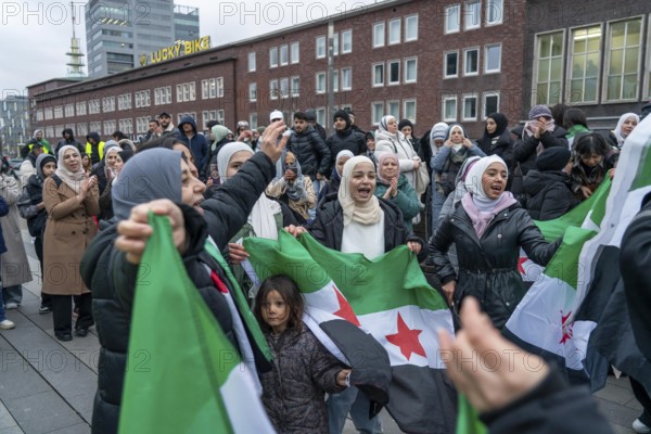 Syrian woman celebrate the end of the Assad regime after the change of power in Syria at a rally on