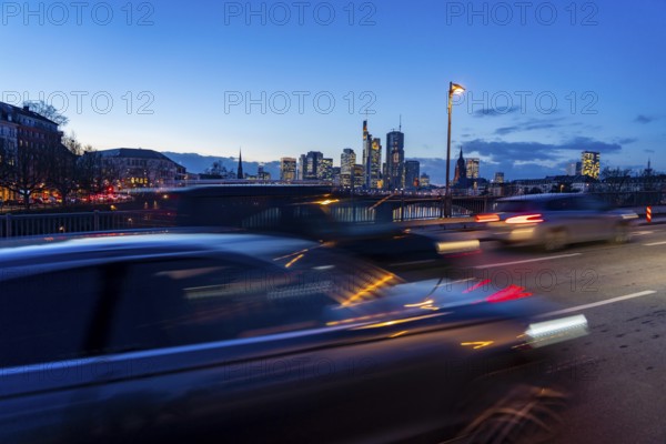 Skyline of the city centre of Frankfurt am Main, road traffic, car, on the raft bridge, dusk, river