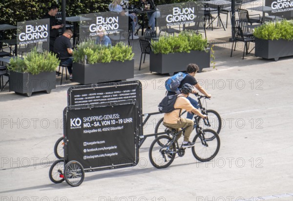 Mobile billboards, pulled by bicycles, advertising for the Kö-Galerie shopping centre in North