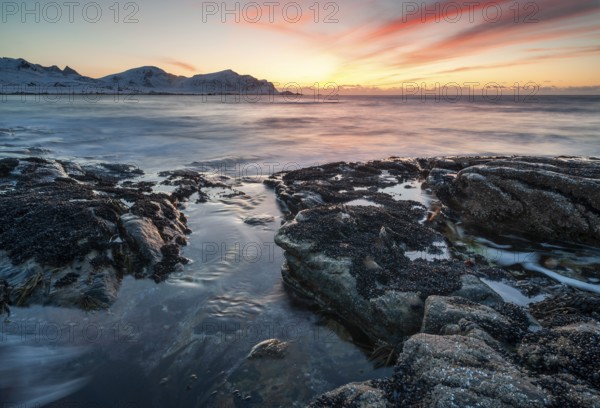 Sunset in winter at Skagsanden, rock formations on the beach at Flakstad, Flakstadøy, Lofoten,