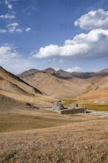 Historic caravanserai Tash Rabat from the 15th century, with yellow hills, Atbashy district in the
