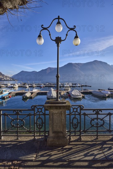 Lantern, forged railing, lakeside promenade, shadow, marina, tree, motorboats, haze, mountain,