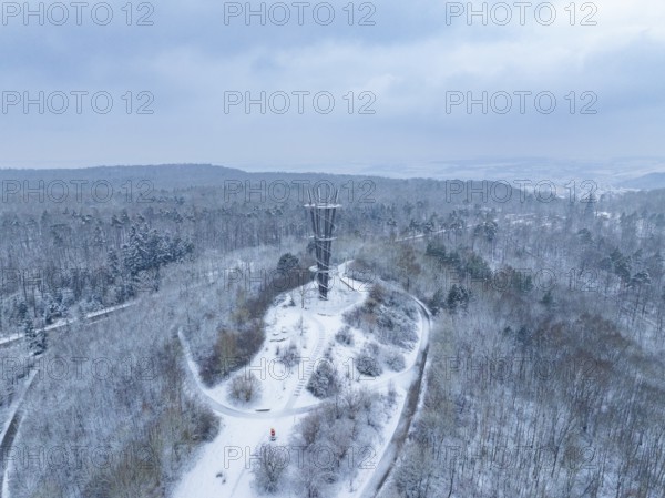Snow-covered paths lead to a tower in a wintry wooded area, cool atmosphere, Schönbuchturm,