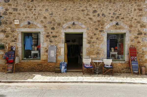 Façade with souvenir shop, typical stone house in Stoupa, former fishing village, Mani, Greece,