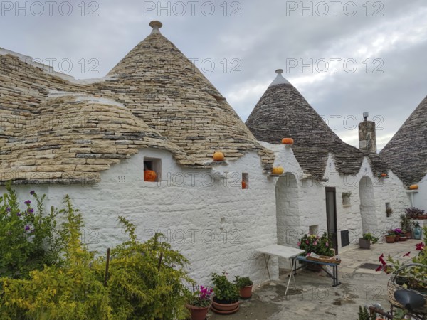 Trulli house decorated with pumpkins, Alberobello, UNESCO World Heritage Site, Apulia, Italy,