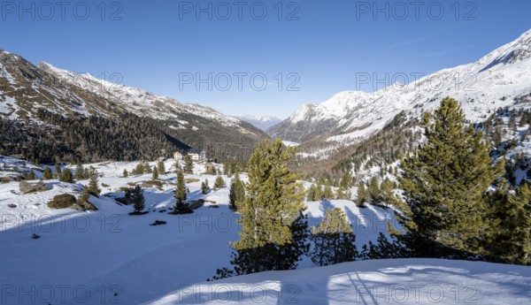 Zufallhütte mountain hut, view of the Martell Valley, snow-covered mountain landscape in winter,