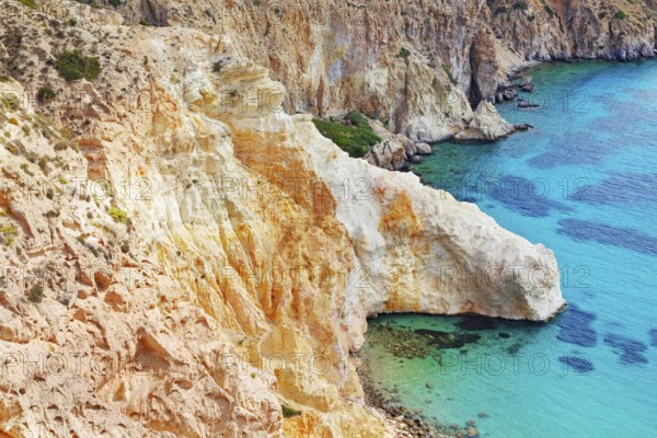 Multicoloured rock formations plunging into the sea, Firopotamos, Milos Island, Cyclades Islands,