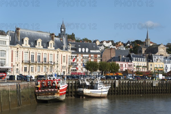 Historic harbour with fishing boats and church towers under a sunny sky, Trouville-sur-Mer,