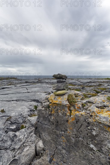 Bizarrely shaped limestone slabs, stacks of stones on the coastline, limestone coast of the Burren,