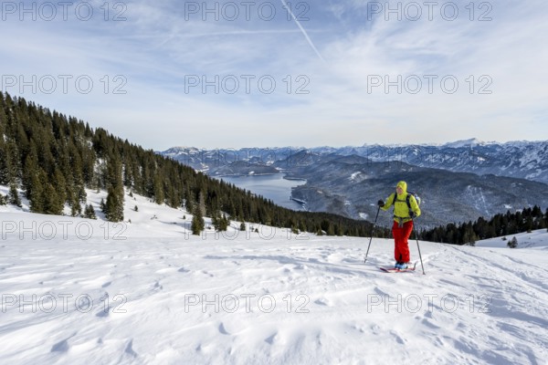 Ski tourers climbing Simetsberg, view of Walchensee, Estergebirge, Bavarian Prealps, Bavaria