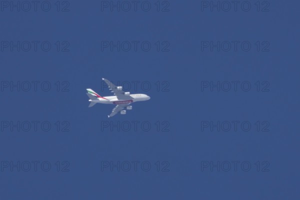 Airbus A380 jet aircraft of Emirates airlines flying in a blue sky England, United Kingdom, Europe