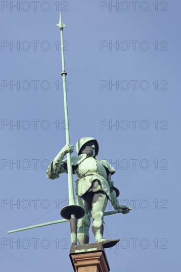 Sculpture knight with helmet, lance on roof, statue, figure, bronze, spear, armour, roof, spear,