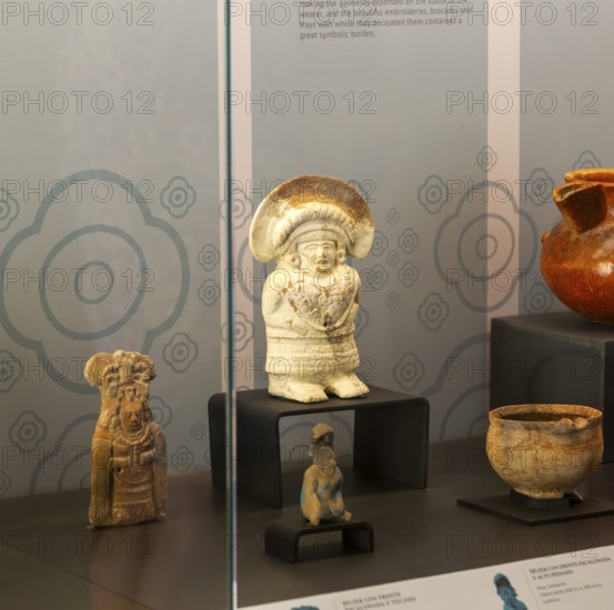 Figurine model of woman in embroidered outfit, from Jaina, Late classical period, Mayan