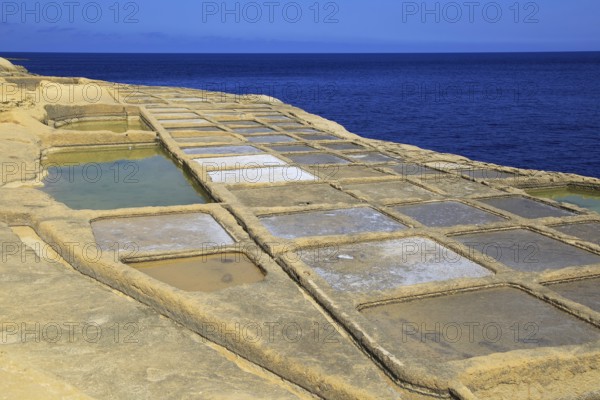 Historic ancient salt pans on coast near Marsalforn, island of Gozo, Malta, Europe