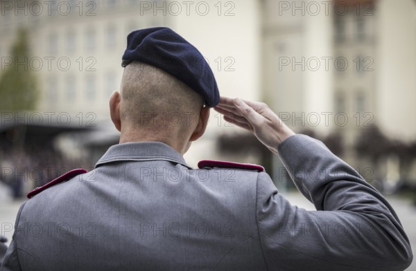 A soldier salutes during the final roll call at the Federal Ministry of Defence to mark the