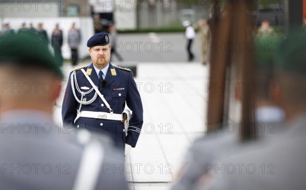 An air force soldier of the guard battalion gives commands to army soldiers of an honour formation