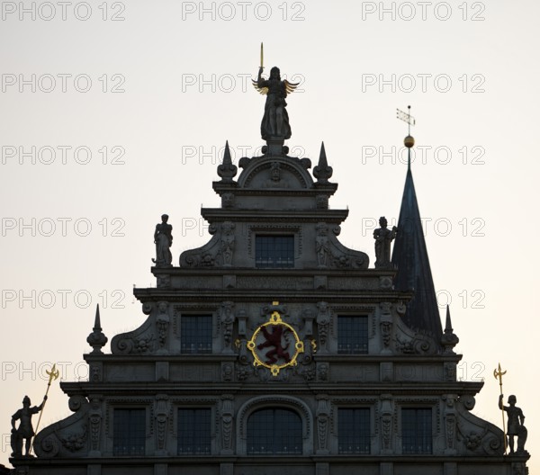 Gewandhaus with Brunswick lion and a church tower of St Martini against the light, Old Town,