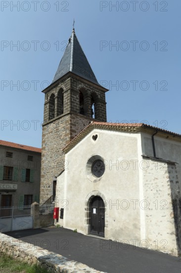 Saint-Roch Church under a clear blue sky in Aubazat village, Haute-Loire, Auvergne-Rhone-Alpes,