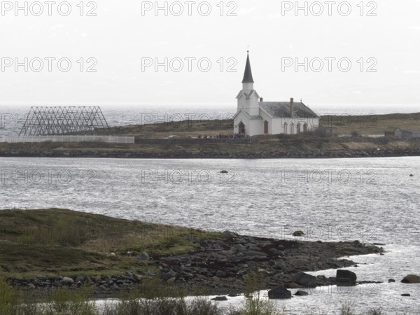Nesseby town church, with congregation standing outside on Whit Sunday, May, Varanger Fjord,