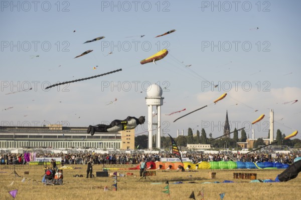 Flying kite in the shape of Batman in front of the tower at the kite festival on Tempelhofer Feld