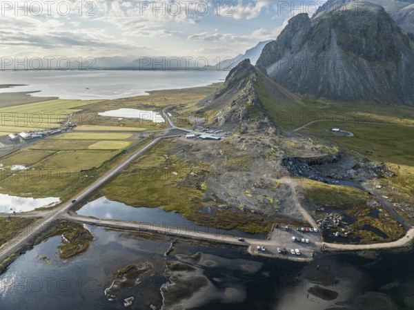 Aerial view of guesthouse, cafe and campsite at Stokksnes, foot of Mt. Vestrahorn, black lava