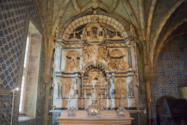 Decorative interior of a church with elaborately decorated altar and architectural works of art,