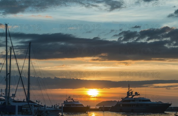Sunset with cloud sky on the pier with yachts