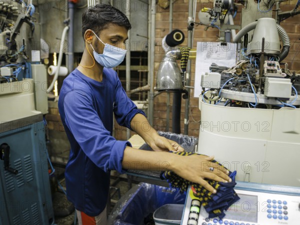 Employees of Inter Market Knit Private Limited producing socks. Lahore, 22.08.2024. Photographed on