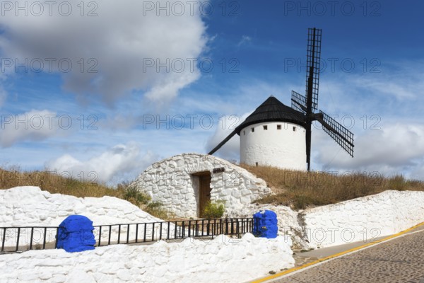 White windmill on a hill with blue sky in the background, Cueva de Mambrino, Craft Museum, Molino