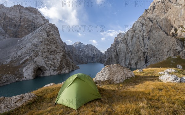 Wild camping, camping in the wilderness with a tent in front of mountain lake Kol Suu, Sary Beles