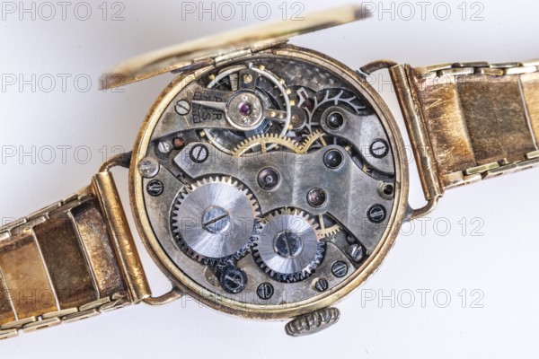 Opened old wristwatch shows the detailed inner movement