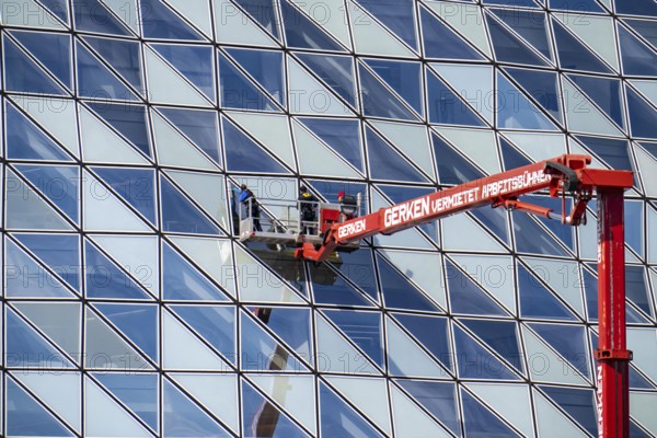 Building cleaners cleaning window panes, cleaning a facade, lorry working platform of the German