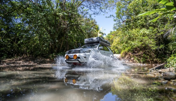 4x4 car drives through a river, water crossing with the off-road car, Costa Rica, Central America
