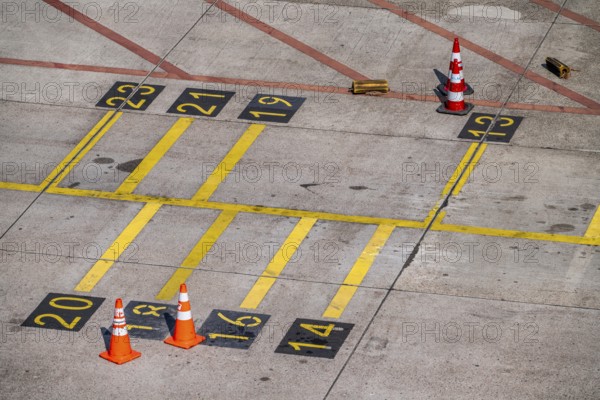 Park markings on the ground, at the terminal, in front of the passenger boarding bridge, holding