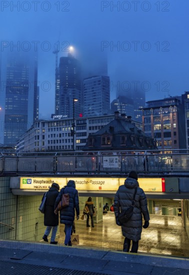 Rainy weather, freezing rain, entrance to Hauptwache underground station, high-rise skyline in