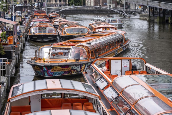 Canal cruises, pier of Lovers Canal Cruises, at Amsterdam Centraal station, Amsterdam Netherlands