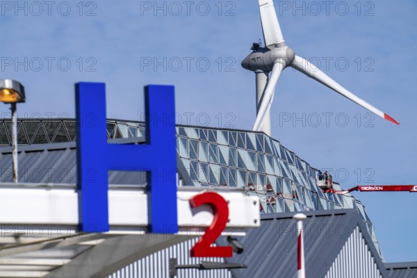 Hydrogen filling station in Antwerp, for cars and lorries, H2 lettering, wind turbine in the
