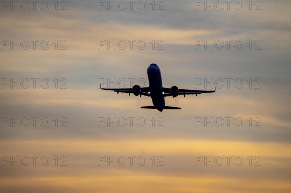 Düsseldorf International Airport, sunset, aircraft taking off from the main runway south, 05R/23L,
