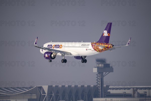 Air Cairo Airbus A320neo approaching Frankfurt FRA airport, air traffic control tower, Fraport, in