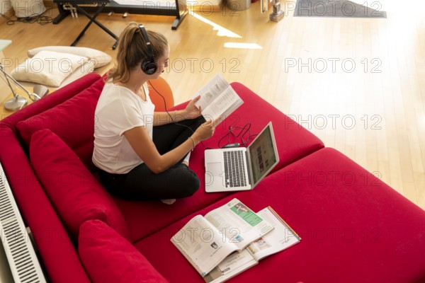 Young student learns at home, online, in conversation with other students