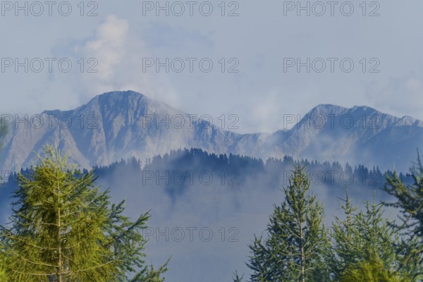 Karawanken, mountains in Slovenia in the background with clouds and fog in the foreground with