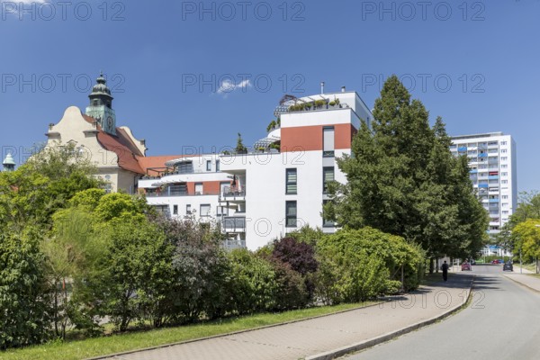Old and new, historic craftsmen's school, modern apartment block and new building block from GDR