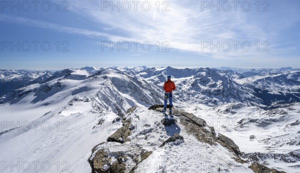 Ski tourer at the summit of Monte Cevedale, looking into the distance, mountain panorama,