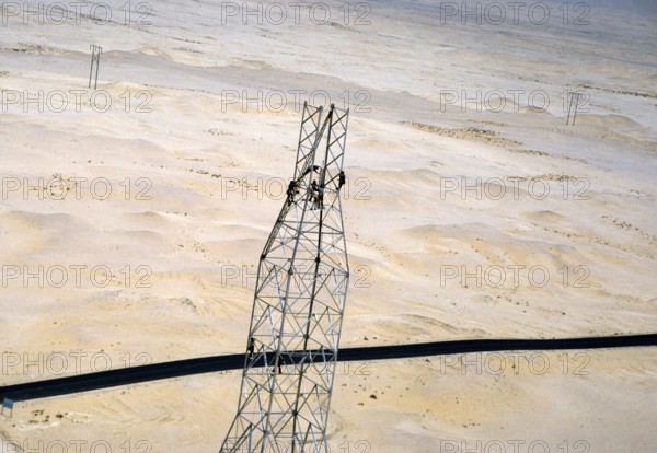 Oil industry in the Ras Tanura region, Saudi Arabia, 1979 Men building a drilling rig in the