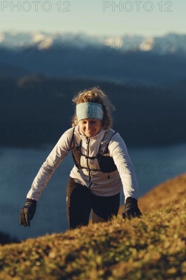 Trail running in autumn on the Jochberg on Lake Walchensee against the wonderful backdrop of the