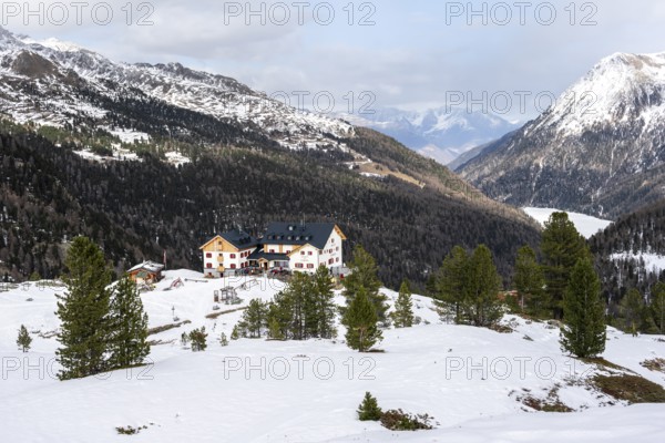Zufallhütte mountain hut, view of the Martell Valley, snow-covered mountain landscape in winter,