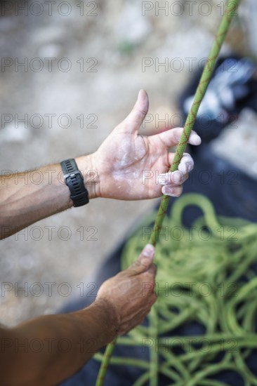 A climber pulls on a rope to climb on the rock, Morsbach, 09.07.2024