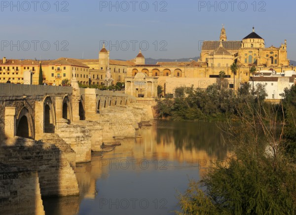 Roman bridge spanning river Rio Guadalquivir leading to the cathedral buildings, Cordoba, Spain,