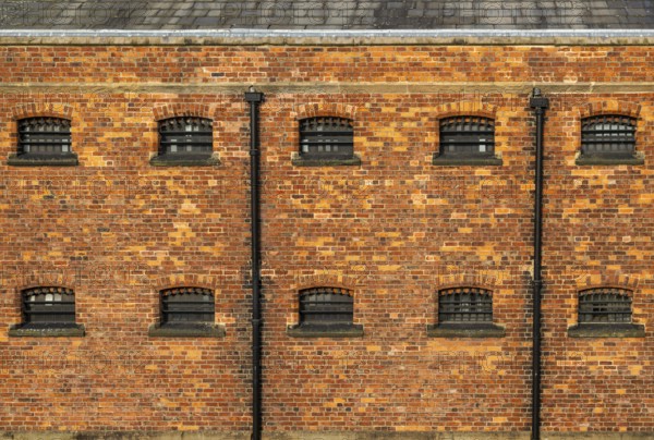 Cell windows with bars, exterior of Victorian jail museum, Lincoln Castle, city of Lincoln,