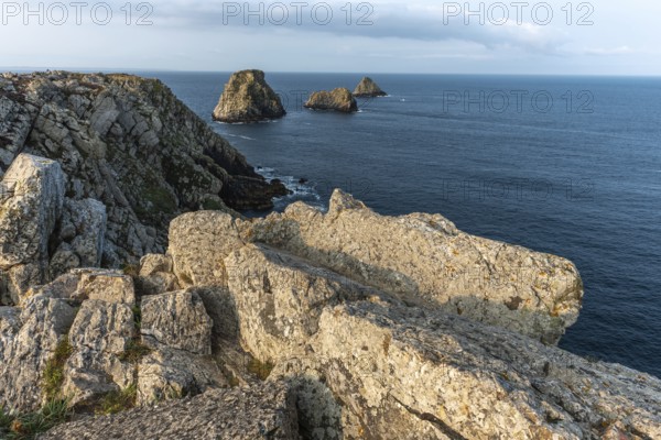 The tip of Pen Hir and its peach stacks. The rocks are jagged and rough, while the water is calm.